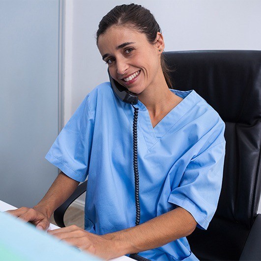 Woman in dental office talking on the phone