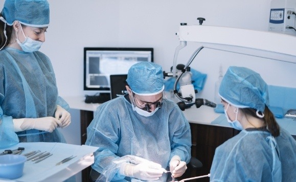 Oral surgeons completing advanced dental implant procedure