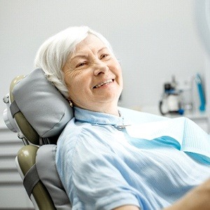 Happy dental patient, glad she could afford her dentures