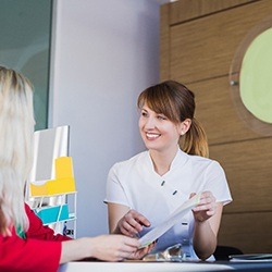 Patient learning about options for paying for implant dentures