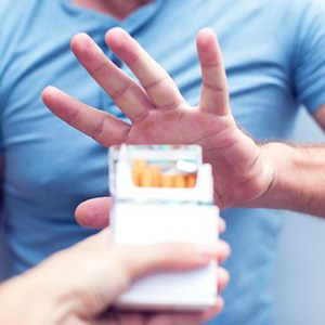 Man declining the offer of a cigarette