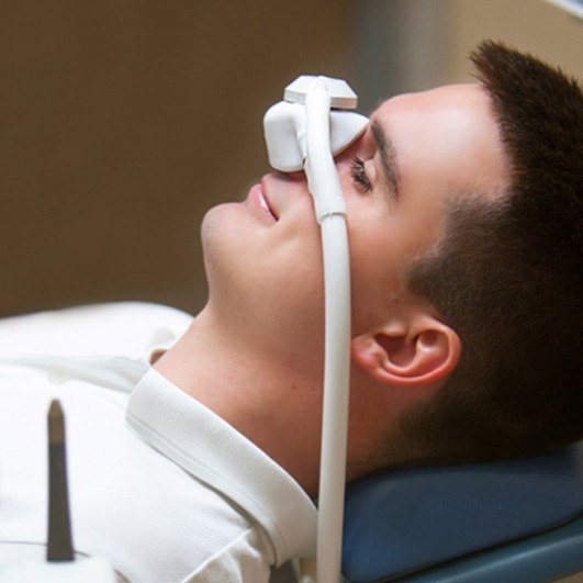 Dental patient relaxing while wearing nitrous oxide nose mask