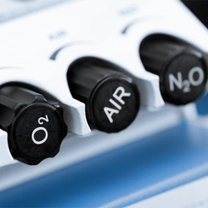 Close-up of black control dials on nitrous oxide machine