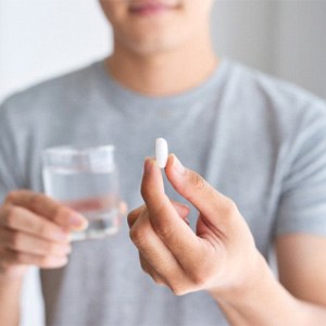 Man taking medication for oral conscious sedation