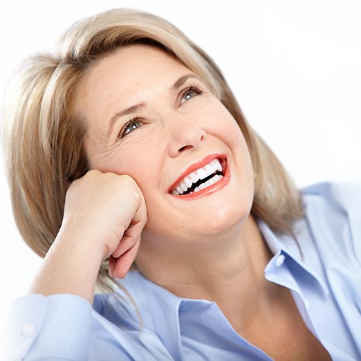 Woman smiling after undergoing full mouth reconstruction in Houston