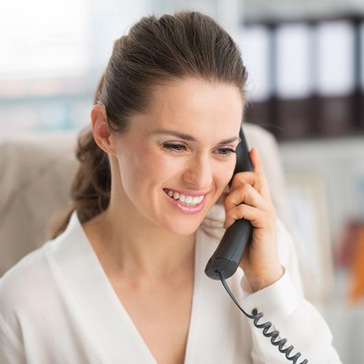 Woman calling Piney Point Dental Implant Centerin Houston