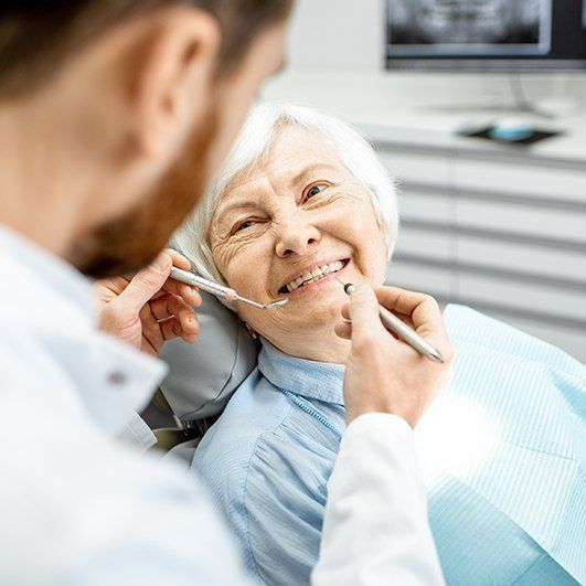 Woman smiling during teeth in an hour dental implant restoration