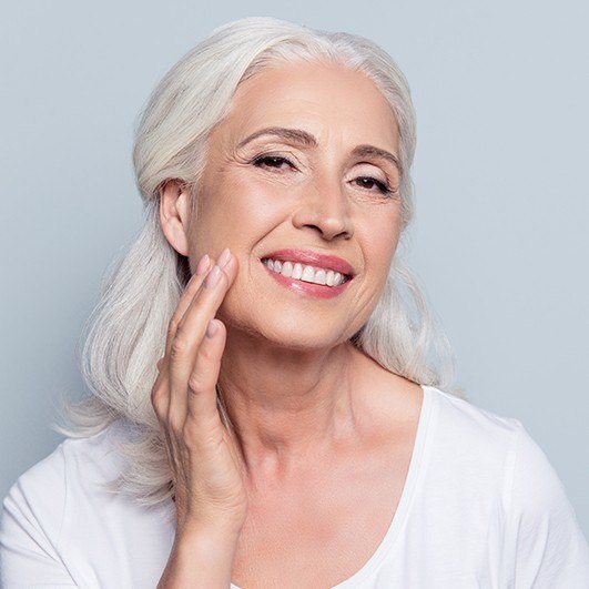 Woman showing off smile after teeth in an hour smile restoration