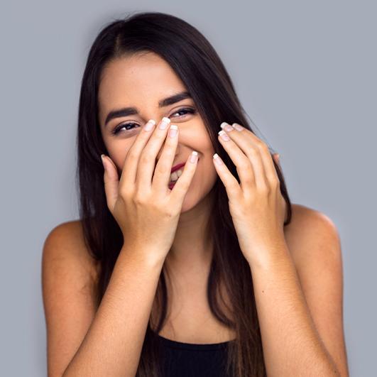 Woman with poor self confidence after tooth loss hiding her smile