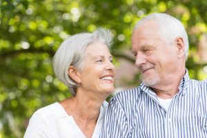 older couple smiling at the park