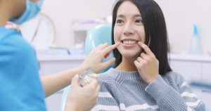 woman talking to dentist pointing at cheek