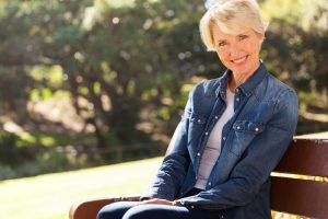 attractive woman sitting on a park bench