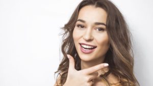 Young woman enjoying cosmetic benefits of dental implants