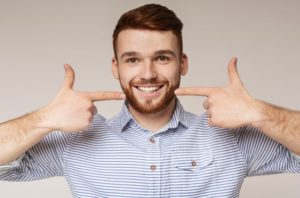 Portrait of young man enjoying dental implant success