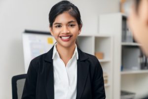 Professional young woman enjoying confidence with dental implants