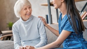 Senior woman learning about dental implants and rheumatoid arthritis