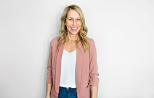 Woman confidently smiling after full mouth reconstruction