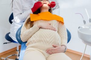 Woman visiting dentist during pregnancy, wondering about dental sedation