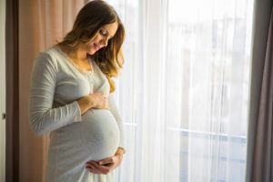 Woman wondering about getting dental implants during pregnancy