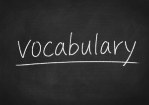 “Vocabulary” underlined and written on chalkboard