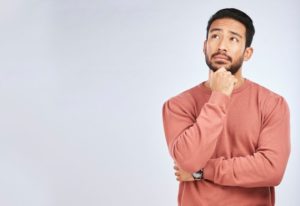 Curious man wondering if dental implants can get cavities