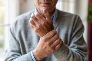 Senior man with rheumatoid arthritis in his hands