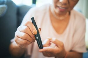 Woman with diabetes checking her blood glucose