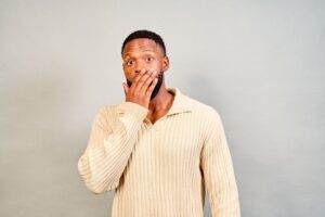 Concerned man covering his mouth