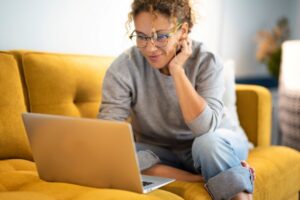 Woman doing research online, looking for a dental implant dentist