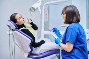 Teen girl talking with dental team member