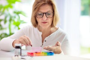Mature woman sorting her weekly medications