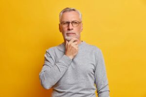 Senior man wearing serious, thoughtful expression 