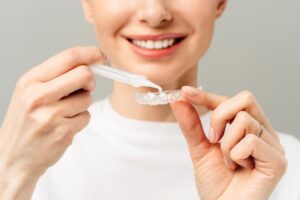Woman preparing to use teeth whitening tray