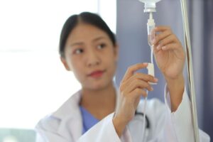 Oral surgery team member preparing IV drip
