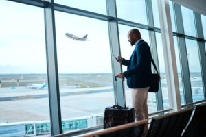 Man standing close to airport window